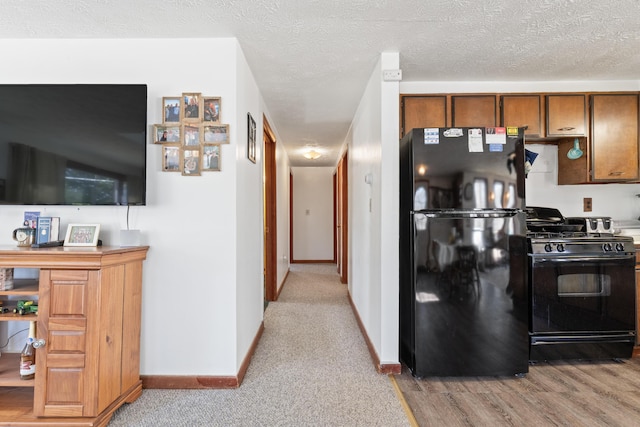 hallway with a textured ceiling and baseboards