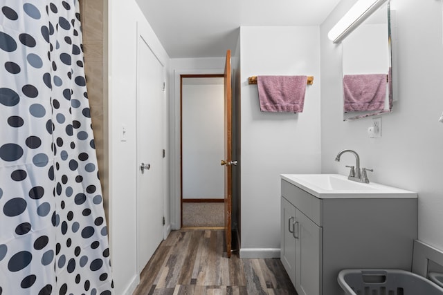 full bath with vanity, baseboards, wood finished floors, and a shower with shower curtain