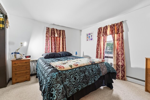 carpeted bedroom with a baseboard radiator