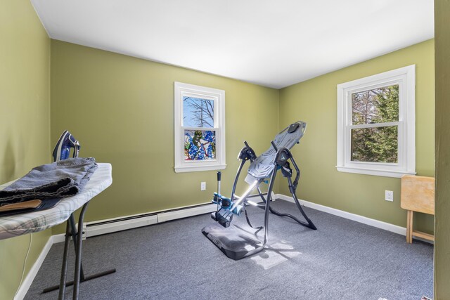 exercise area with baseboards, a baseboard heating unit, and carpet flooring