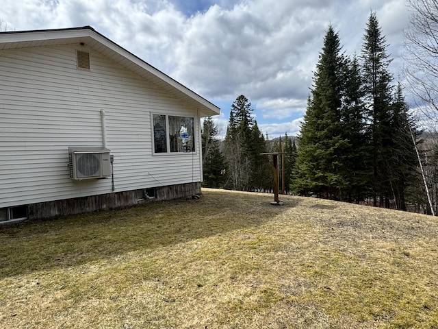 view of home's exterior with a yard and ac unit