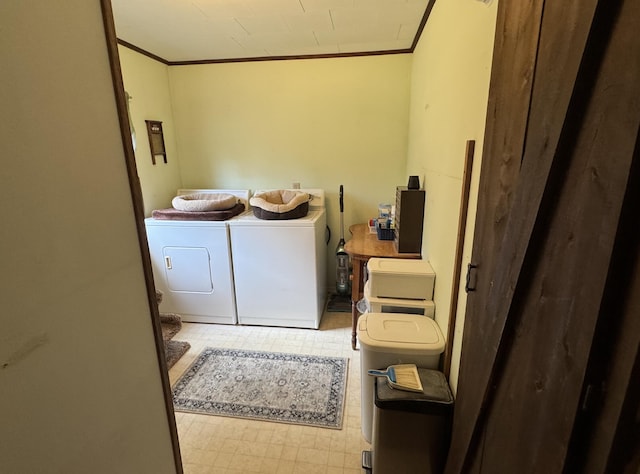 laundry area with tile patterned floors, ornamental molding, and washing machine and dryer
