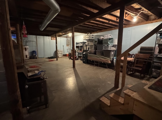 unfinished below grade area featuring water heater