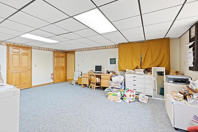 finished basement featuring carpet and a paneled ceiling