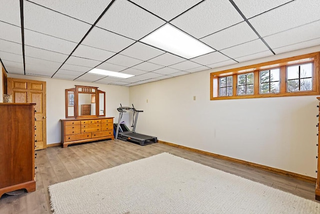 workout area featuring wood finished floors and baseboards