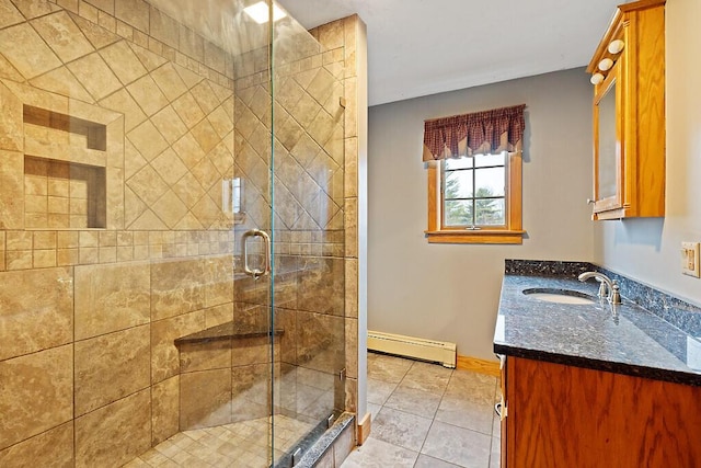 full bath featuring a baseboard radiator, tile patterned floors, a shower stall, vanity, and baseboards