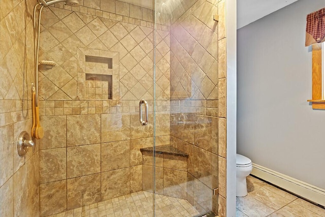 full bathroom with a shower stall, toilet, baseboard heating, and baseboards