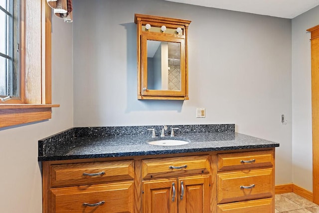 bathroom featuring tile patterned floors, vanity, and baseboards