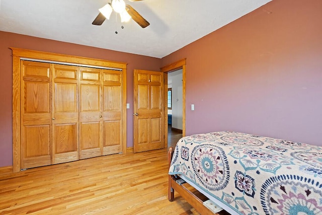 bedroom with a closet, ceiling fan, and light wood-type flooring