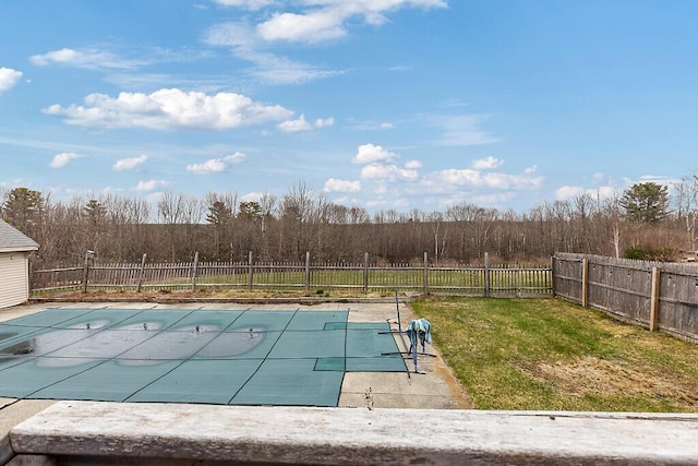 view of pool with a fenced in pool, a yard, and a fenced backyard