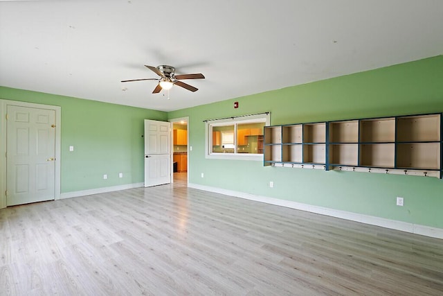 unfurnished living room with wood finished floors, ceiling fan, and baseboards