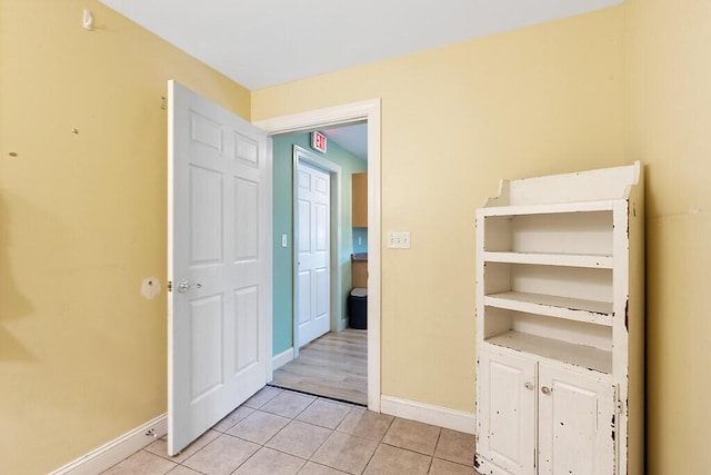 interior space featuring baseboards and light tile patterned floors