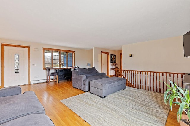 living room with light wood finished floors and a baseboard radiator