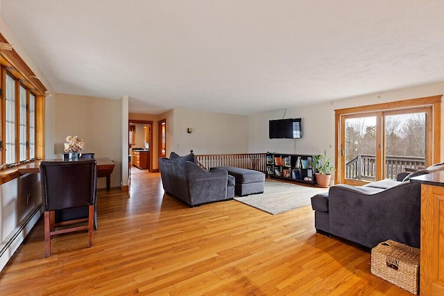 living area featuring a baseboard radiator and light wood-type flooring
