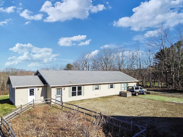 rear view of house with fence