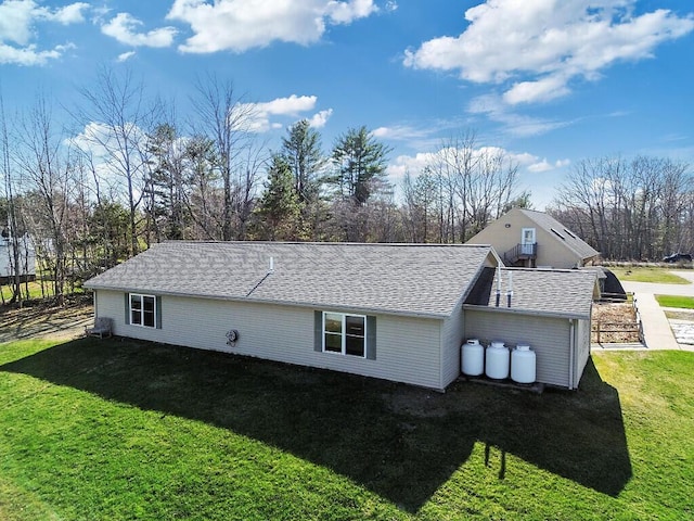 rear view of property with a yard