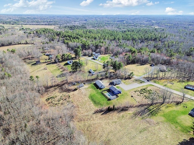 birds eye view of property with a view of trees