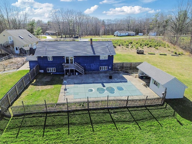 exterior space featuring a fenced backyard, stairway, a fenced in pool, a patio area, and a lawn
