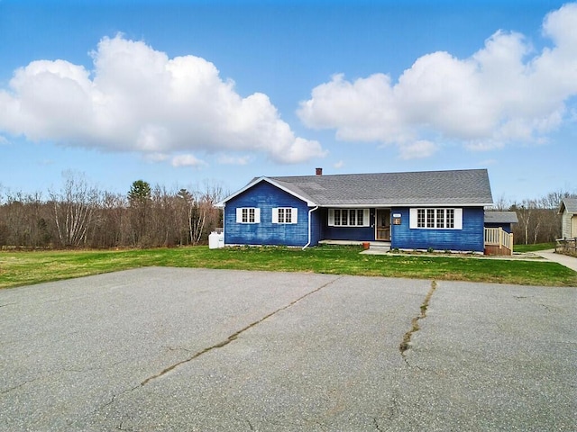 view of front of property with covered porch and a front yard