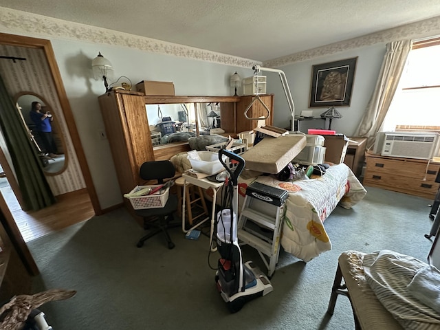 bedroom featuring cooling unit, a textured ceiling, and carpet flooring