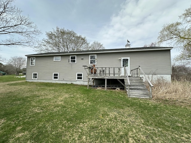 back of house with a deck and a yard