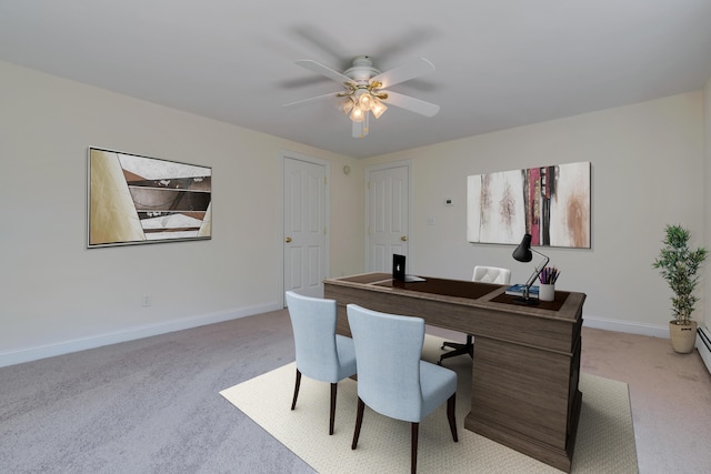 office space with a ceiling fan, light carpet, and baseboards