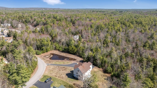 aerial view featuring a wooded view