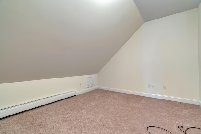 bonus room featuring a baseboard heating unit, vaulted ceiling, light carpet, and baseboards