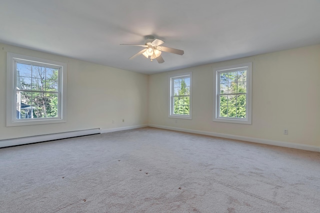 empty room featuring baseboards, ceiling fan, carpet, and a baseboard heating unit
