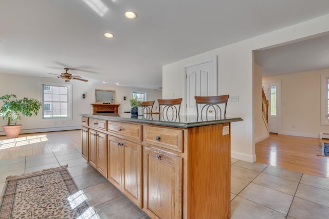 kitchen with light tile patterned flooring, recessed lighting, a ceiling fan, and a healthy amount of sunlight