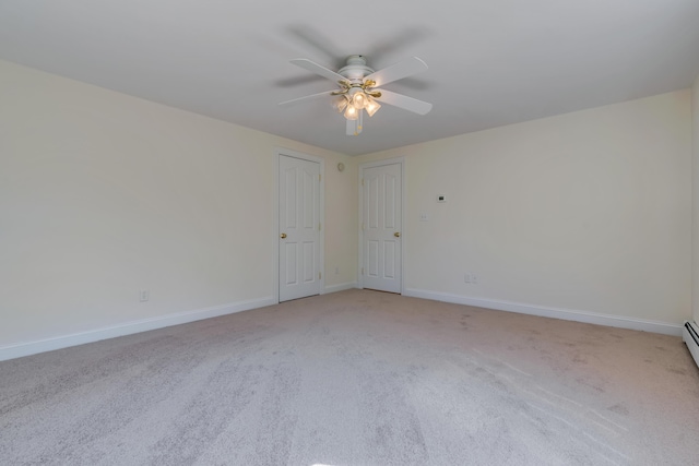 empty room featuring light colored carpet, ceiling fan, and baseboards