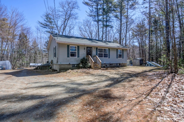 view of front of property featuring an outbuilding and a storage shed