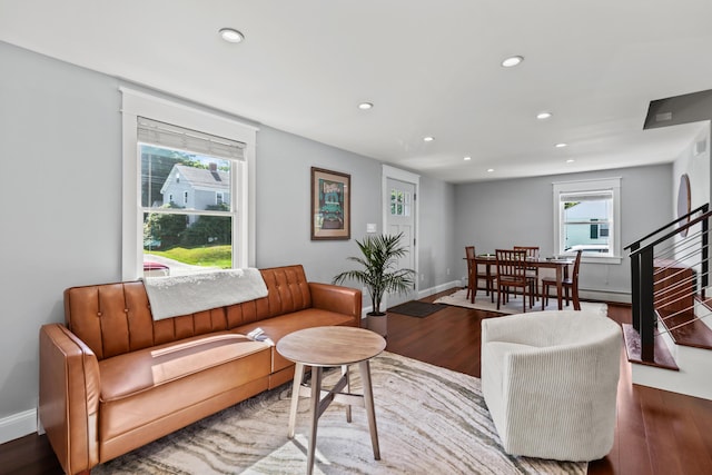 living room featuring recessed lighting, stairs, baseboards, wood finished floors, and a baseboard radiator