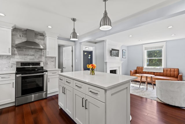 kitchen featuring electric stove, wall chimney range hood, backsplash, a fireplace, and open floor plan