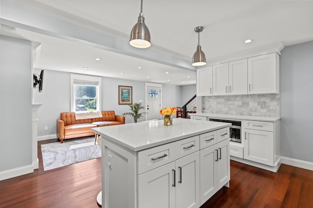 kitchen featuring recessed lighting, dark wood finished floors, light countertops, and tasteful backsplash