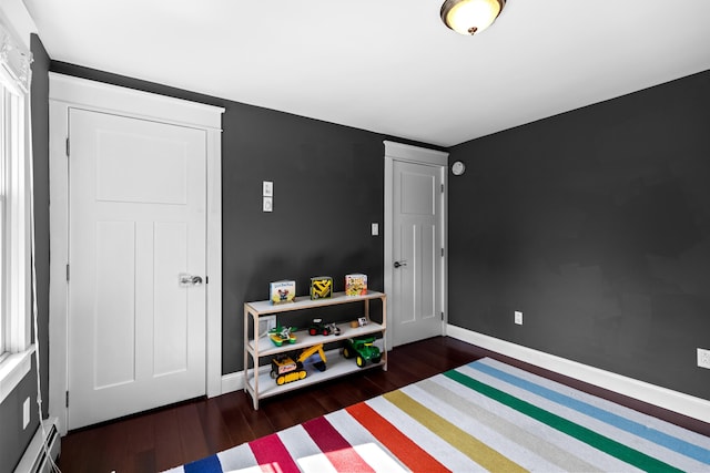 interior space featuring wood finished floors and baseboards