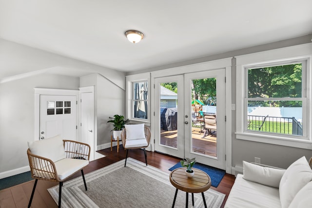 living area featuring wood finished floors, french doors, and baseboards