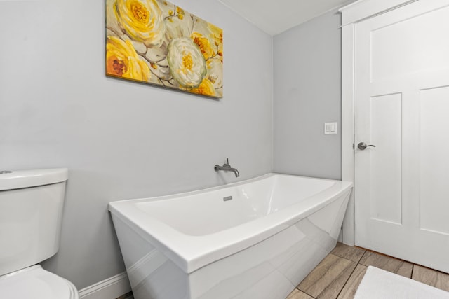 bathroom with toilet and wood finished floors