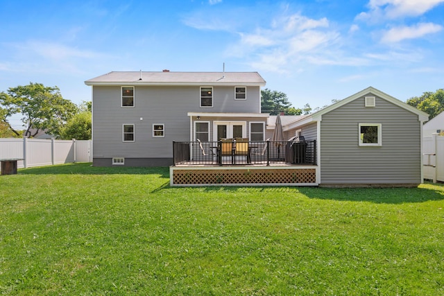 rear view of property featuring a wooden deck, a yard, and a fenced backyard