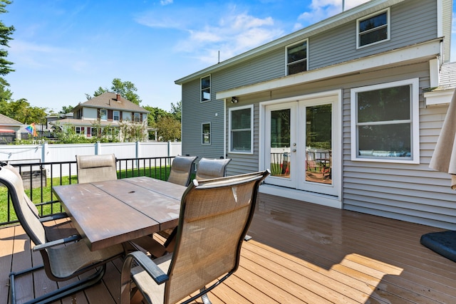 deck featuring fence private yard, french doors, and outdoor dining space