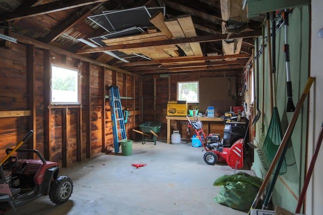 misc room featuring a garage and a workshop area