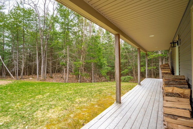 wooden deck featuring a yard