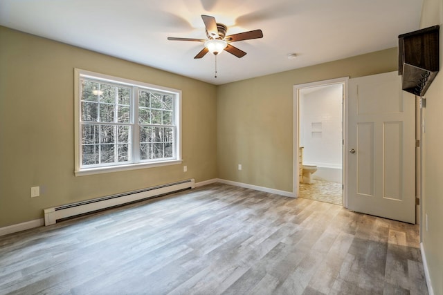 spare room with a baseboard radiator, ceiling fan, light wood-type flooring, and baseboards