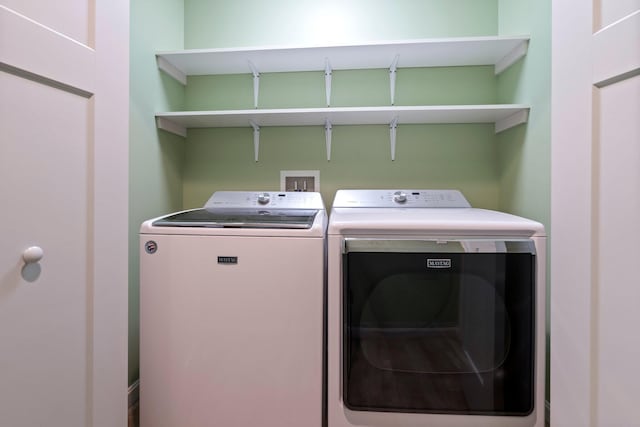 clothes washing area featuring washing machine and dryer and laundry area
