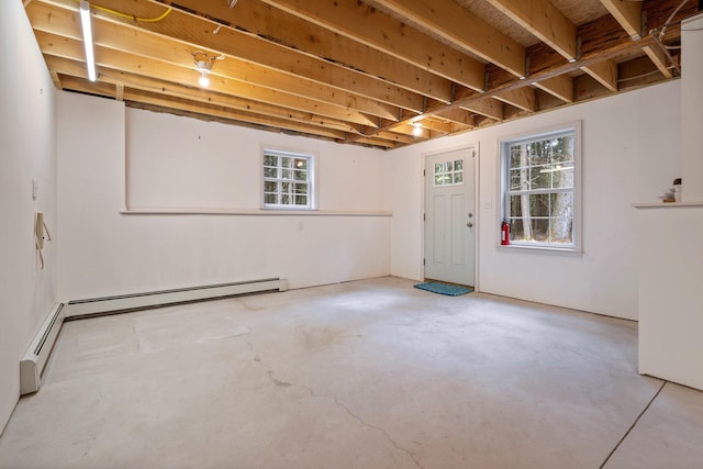 below grade area featuring a healthy amount of sunlight and a baseboard heating unit