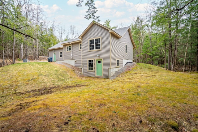 rear view of house featuring a lawn
