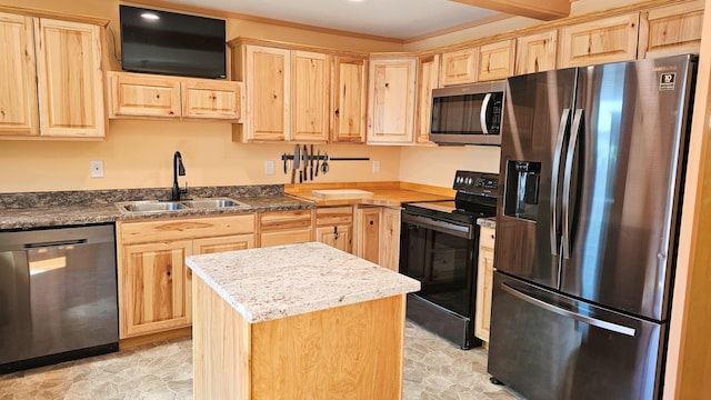 kitchen featuring light brown cabinets, stainless steel appliances, a center island, and a sink
