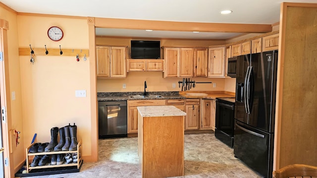 kitchen featuring a sink, light brown cabinets, a center island, black appliances, and recessed lighting