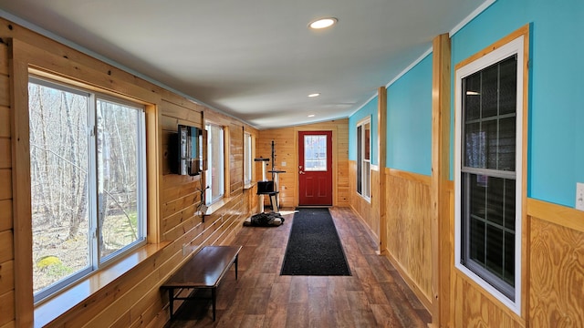 interior space with dark wood-style floors, recessed lighting, and wooden walls