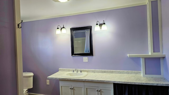 bathroom featuring vanity and toilet
